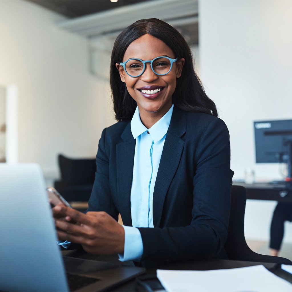 A woman in bright blue glasses smiling